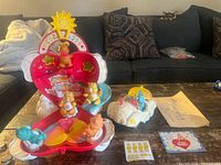 Open heart cloud playset with figures, cloud vehicles, instruction sheet and stickers visible
