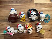 Front view of eight Mini Puft figures with their respective accessories