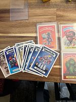 Fanned loose cards alongside two sleeved cards