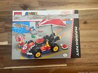 Front of LEGO box showing Mario Kart build and piece count