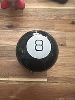 Top view showing white label with black 8 on black sphere