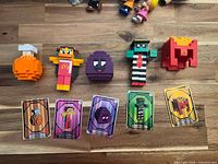 Front view of five figures and five cards