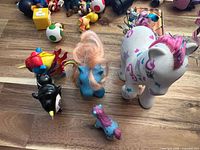 Group shot of five pony-themed figures on wood surface