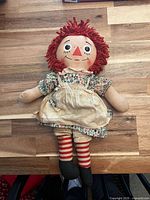 Front view of Raggedy Ann doll showing size, clothing and facial details