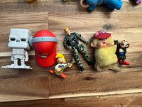 Front view of six assorted figures lined on wooden surface