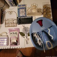 Group shot showing foot spa, Epsom salt, night lights, shelves, soap holder, scrubber, hooks