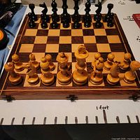 Open chessboard with all wooden pieces set up