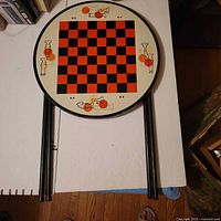 Round metal chess folding table top with red/black board and chess graphics