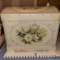 Front view showing floral painting and footed base