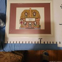 Front view of framed cross-stitch showing design, mat and frame