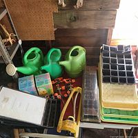 Overview of three watering cans, seed trays, bug traps, hose connectors