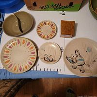 Group shot showing assorted Red Wing plates, Monmouth casserole, Haeger jar