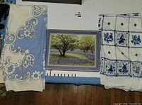 Both tablecloths folded beside one placemat front