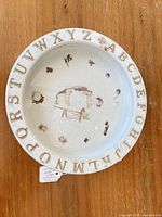 Top view of bowl showing alphabet rim and central child scene