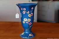 Front view of cobalt hexagonal trumpet vase with prunus decoration