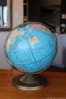 Front view of Cram's Imperial globe on brass-tone base
