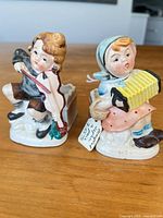 Front view of both child figurine planters
