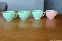 Front view of four cups showing colors and shape