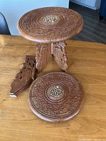 Tabletop on base with detached leg and separate carved top showing mother-of-pearl inlay