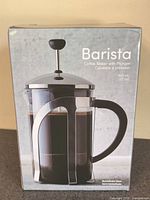 Front of sealed box showing Barista coffee maker