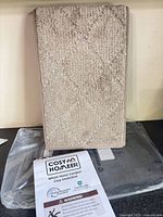 Front view of stacked beige treads with Cosy Homer leaflet