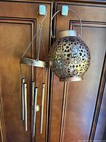 Wind chime and lantern hanging side by side