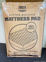 Front of Utopia Bedding mattress pad box showing product name and material