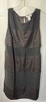 Front view of sleeveless black dress with crochet lace bands