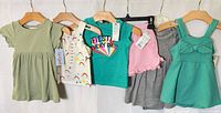 All six garments hung side by side