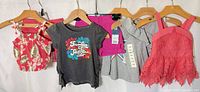 All six garments hanging on hangers