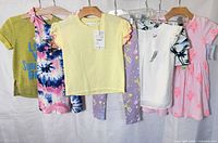 Group shot of all seven garments hanging