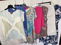 All seven garments on hangers showing styles and colours