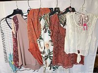 Group shot of all six garments on hangers