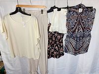 Group shot showing five garments on hangers