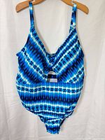 Front view of blue patterned one-piece swimsuit on hanger