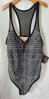 Front view of black and white geometric print one-piece swimsuit with tags attached