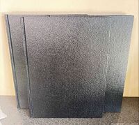 Front view showing three black hardcover drawing books