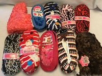 All ten pairs of assorted slippers displayed
