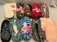 Group shot of all ten packaged slipper pairs in two rows