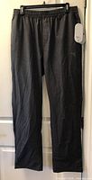 Full view of Diadora black jogger pants hanging