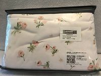 Front view of packaged floral duvet cover set showing pattern and zippered bag