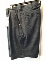Front view of new FarWest navy dress shorts on hanger, tags visible
