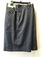 Front view of navy dress shorts showing tags, pockets, flat front