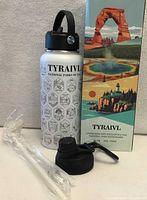 Bottle front, extra lid, straw, brush and retail box