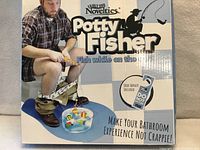 Front of boxed Potty Fisher showing product graphics and branding