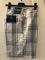 Front view of plaid PGA Tour golf shorts with tags attached