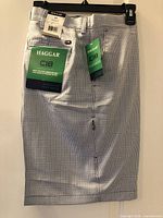 Front view of Haggar Cool 18 shorts with hangtags visible