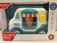 Front view of boxed Huanger ice cream truck toy showing product and age rating