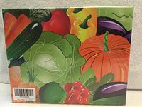 Shrink-wrapped front of puzzle box showing vegetable illustration