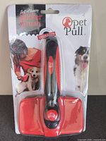 Front of sealed retail package showing Pet Pull self-cleaning slicker brush